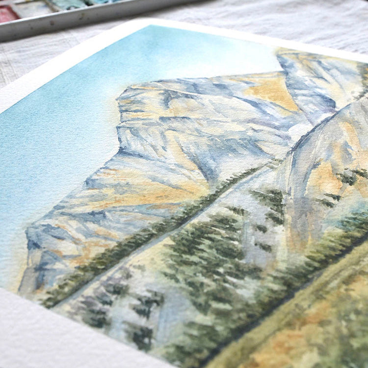 Artistic depiction of mountains and trees on a textured surface